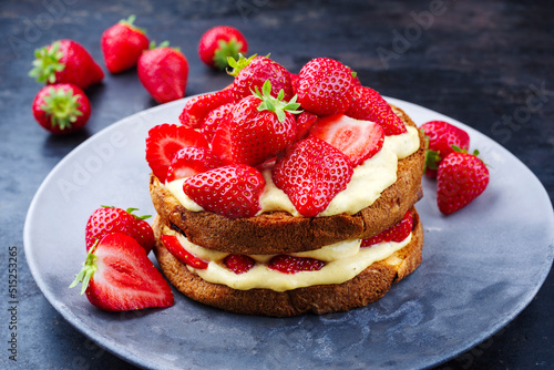 Traditional roasted Italian panettone tiramisu with vanilla custard curd and strawberries served as close-up in a design plate