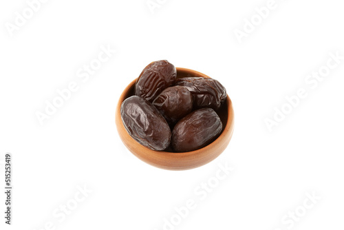 Iranian dates balanced in ceramic bowl on white background. Natural substitute for sweets. Healthy food during religious fasting. Dried fruits contain many vitamins and trace elements