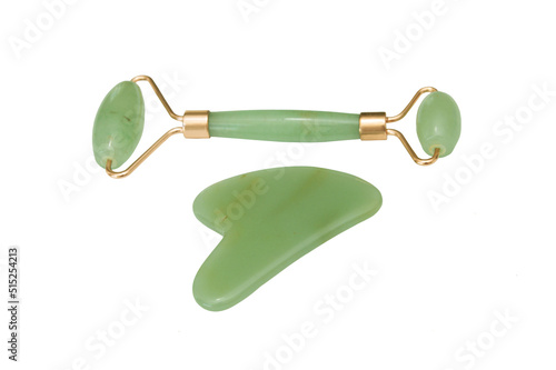 Green Roller Face Guasha Scraper and Neck Scraper isolated on white background. Facial massager with jade stone. Anti-aging, lifting and toning care at home. Items for SPA procedures