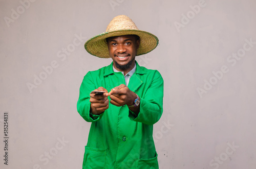 afro man with credit card in studio on white background.farmer taking a loan in a bank for small business in agriculture © Vic Josh