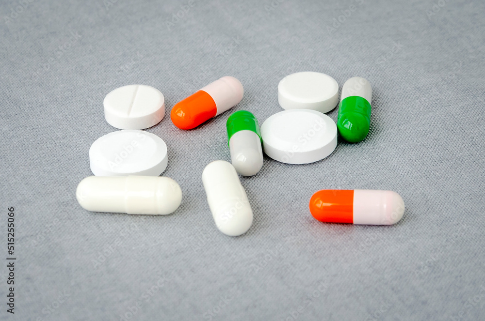 Medication: capsules and pills on a gray background. Medical concept. Close-up Medication: capsules and pills on a gray background. Medical concept. Close-up