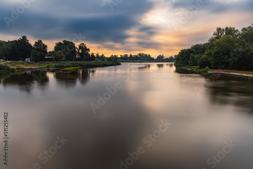 Beautiful cloudy sunrise at summer over long silent Odra river © wierzchu92