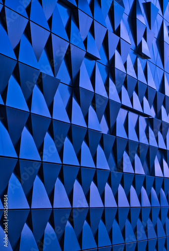 a blue metallic wall composed of triangles