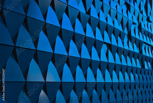 a turquoise metallic wall composed of triangles