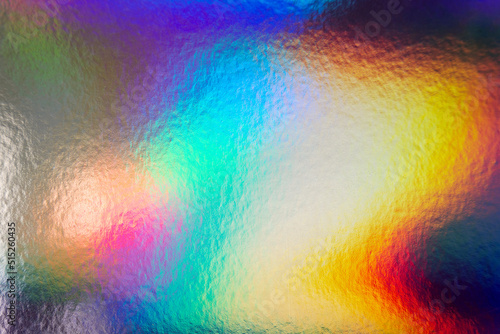 Colorful holographic iridescent holo bg texture  cold vs. warm  blue  yellow and red abstract background
