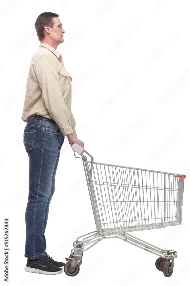 Full length side view of handsome young man standing with shopping trolley Full length side view of handsome young man standing with shopping trolley