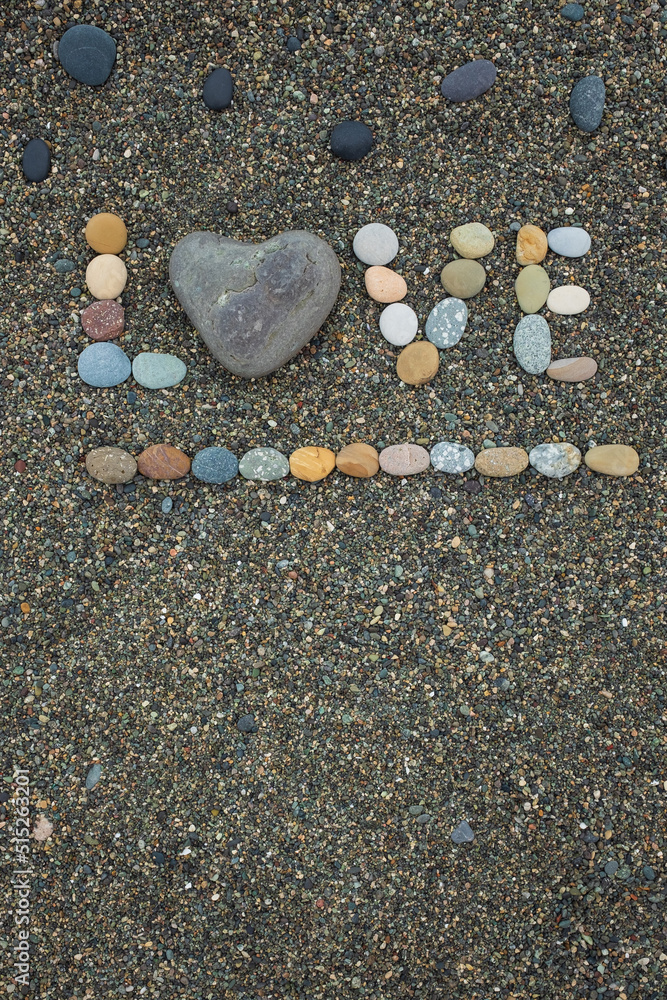 Word love made from stones on sandy beach. Word love made from stones on sandy beach.