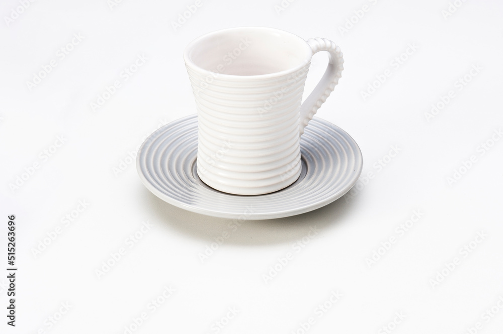 Modern white empty ceramic cup with saucer, isolated on white Modern white empty ceramic cup with saucer, isolated on white