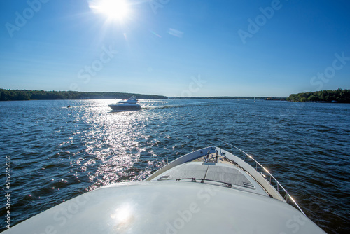 A motor yacht is moving towards our yacht and also a jet skier in the distance Excellent solar on a pond in the Moscow region