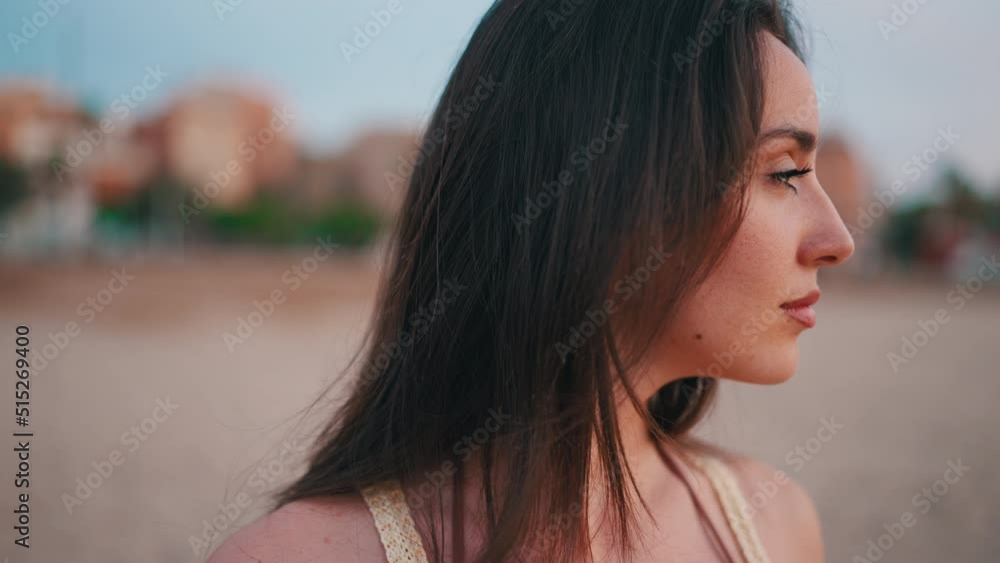 Close-up of the profile of Beautiful brown-haired woman with long hair. Gorgeous girl with freckles and long eyelashes. slow motion Close-up of the profile of Beautiful brown-haired woman with long hair. Gorgeous girl with freckles and long eyelashes. slow motion