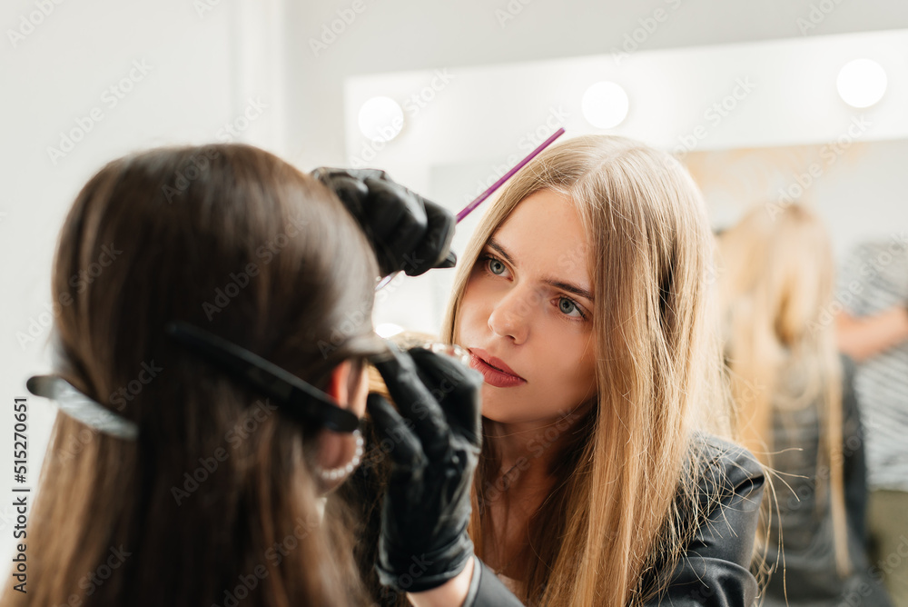 Master makes eyebrows in a beauty salon Master makes eyebrows in a beauty salon