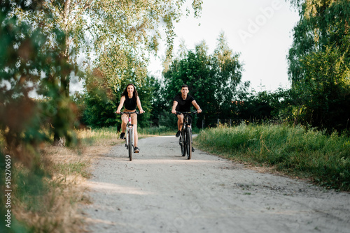 Young couple spend time riding bicycles together in the park