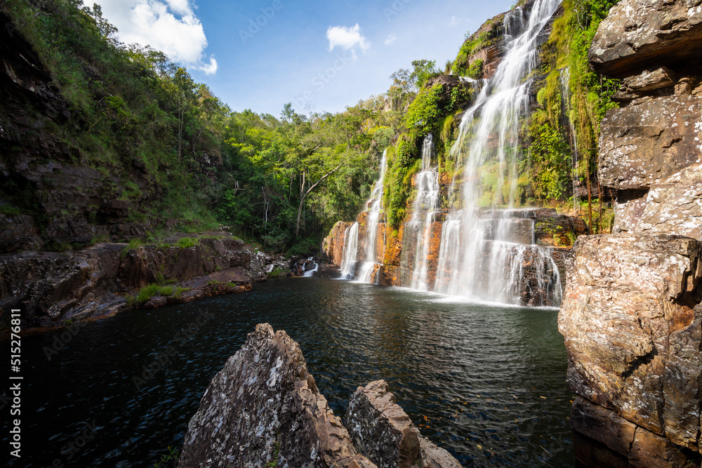 Fototapeta premium Beautiful view to big wild green rocky waterfall