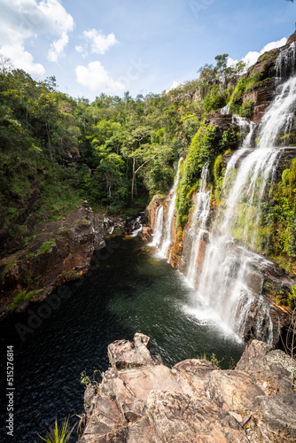 Beautiful view to big wild green rocky waterfall