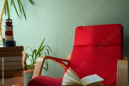 open book on a red armchair photo