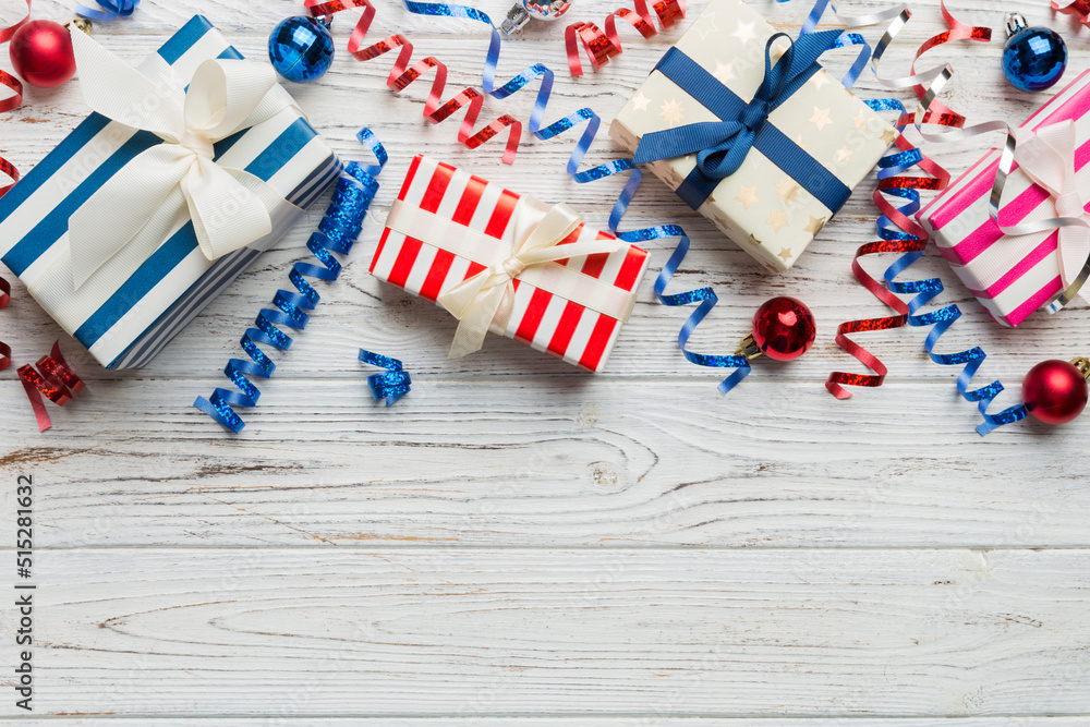 Holiday flat lay with gift boxes wrapped in colorful paper and tied decorated with confetti on colored background. Christmas, Birthday, Valentine and sale concept, top view Holiday flat lay with gift boxes wrapped in colorful paper and tied decorated with confetti on colored background. Christmas, Birthday, Valentine and sale concept, top view