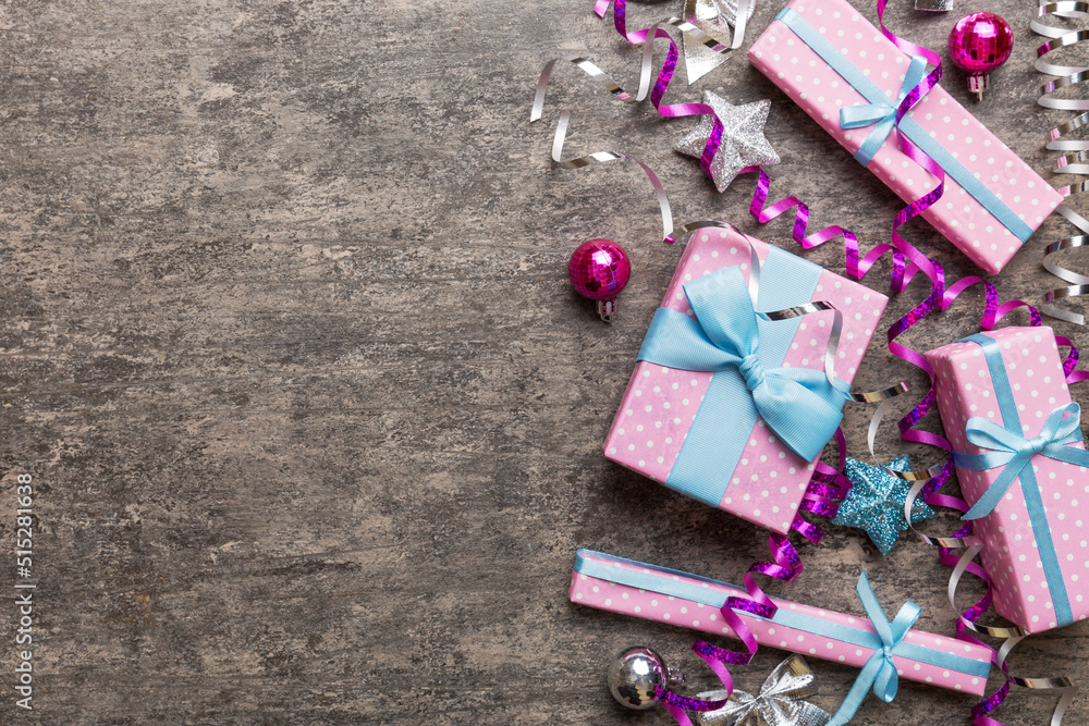 Holiday flat lay with gift boxes wrapped in colorful paper and tied decorated with confetti on colored background. Christmas, Birthday, Valentine and sale concept, top view Holiday flat lay with gift boxes wrapped in colorful paper and tied decorated with confetti on colored background. Christmas, Birthday, Valentine and sale concept, top view