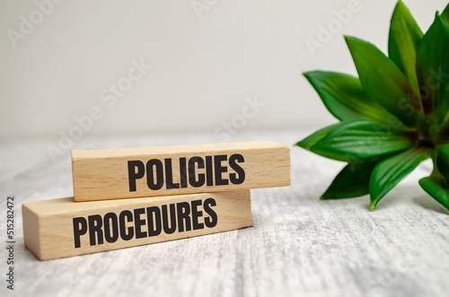 policies and procedure word written on wood block on white background photo