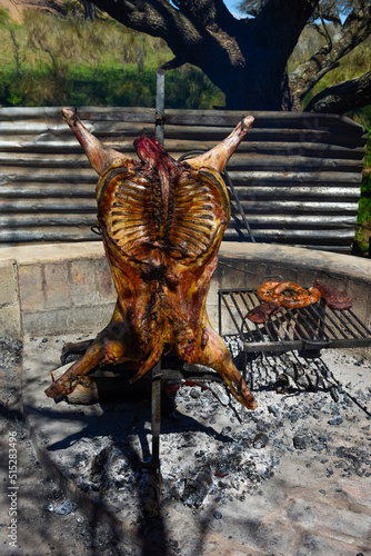 Lamb on the spit, cooked with the traditional Argentine method, La Pampa province, Patagonia, Argentina.