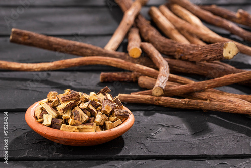 Close up of Ayurvedic herb Liquorice root,Licorice root, Mulethi or Glycyrrhiza glabra root on a wooden surface is very much beneficial for Soothes your stomach,poisoning, stomach ulcers. photo