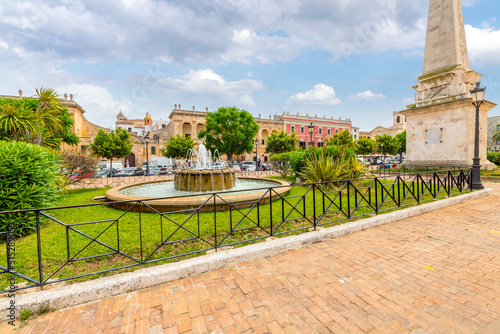 Water fountains and an obelisk at the center of the Placa des Born, the main town square and park in the historic center of Ciutadella de Menorca.