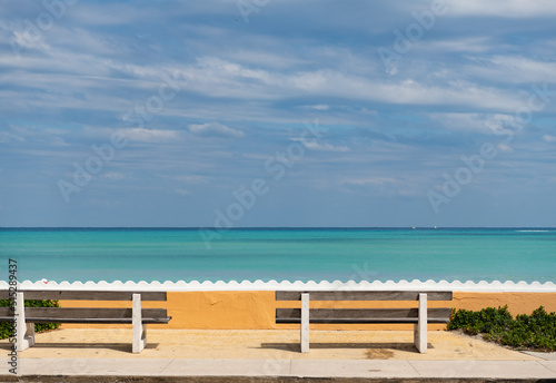 empty wood bench with view on sky and ocean