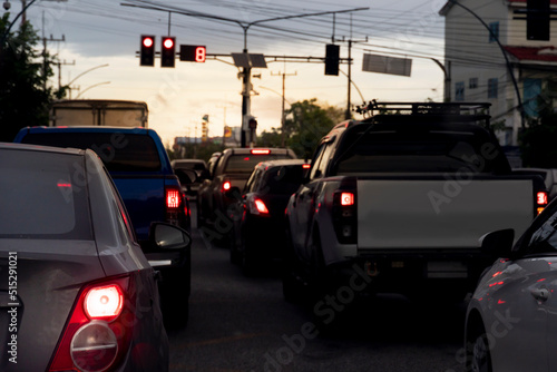 Abstract and blurred of rear side cars stop on the asphalt road by traffice control red color in Thailand. Traffic congestion. long queues in the evening.