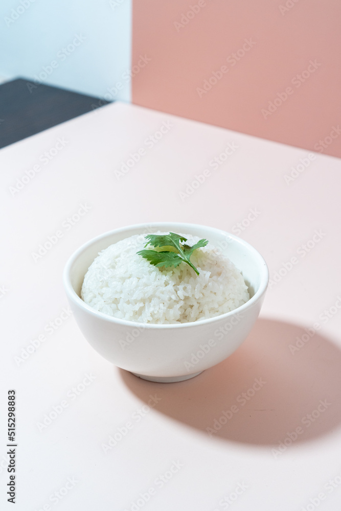 A studio shot of a bowl of rice on a plain background. A studio shot of a bowl of rice on a plain background.