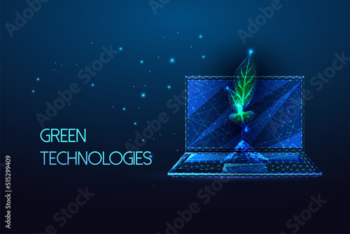 Concept of eco friendly technologies, green IT with laptop and sprout in futuristic glowing on blue 