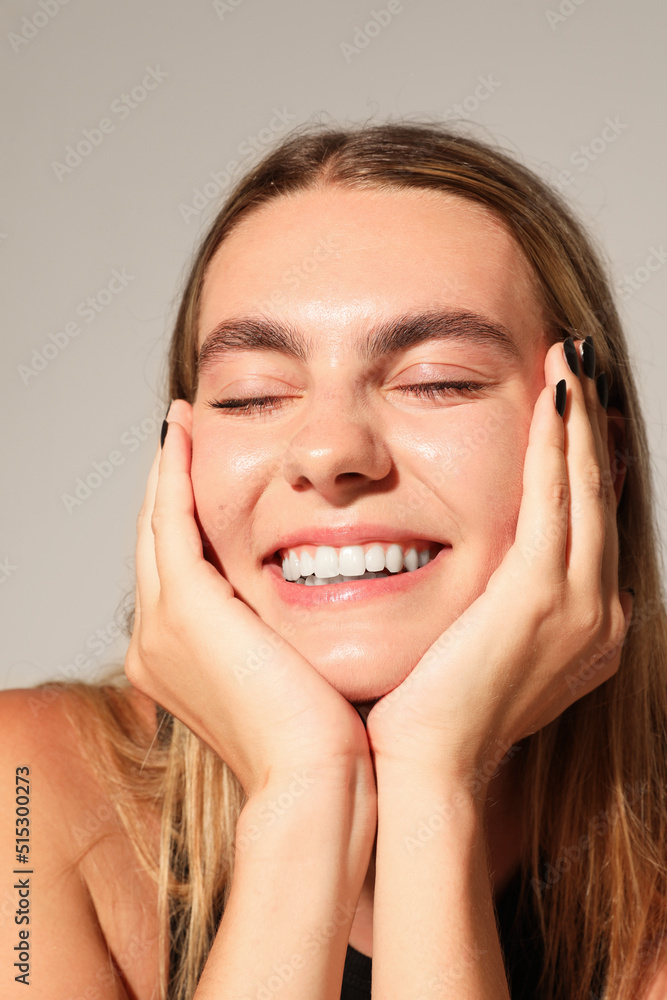 Young optimistic woman, poses on white wall. Mind set concept. Mock-up. Vertical Young optimistic woman, poses on white wall. Mind set concept. Mock-up. Vertical