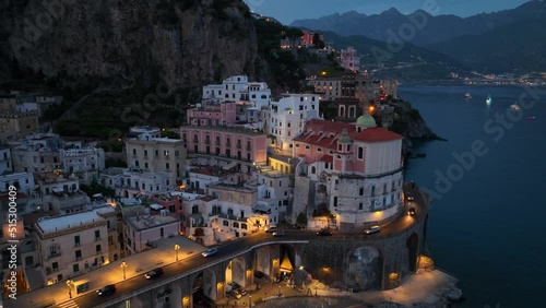 flying over the coast of Amalfi at night, Mediterranean coastline of Amalfi in Italy in the evening, aerial view of famous Italian resort of Amalfi near Naples photo