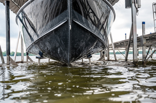 Boat with a hydraulic dock lift sitting above the water line on a lake.