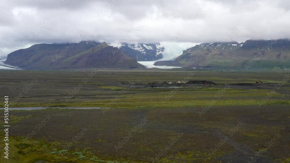 Iceland glacier wide shot with clouds and drone video moving up. Iceland glacier wide shot with clouds and drone video moving up.