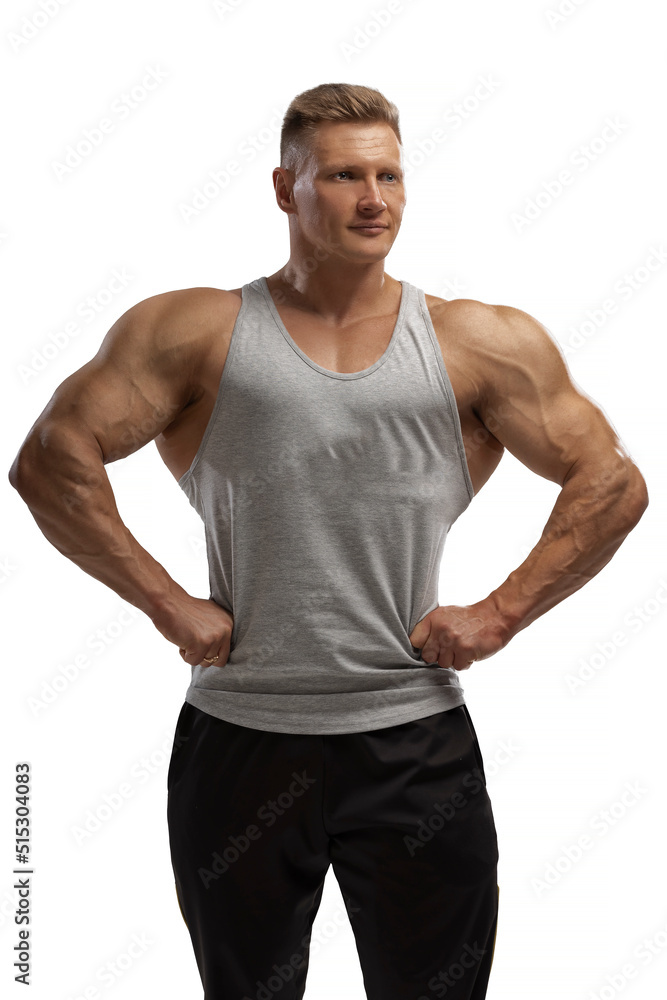 Hight-level bodybuilder posing in tank-top in white background Hight-level bodybuilder posing in tank-top in white background
