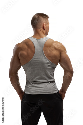 Hight-level bodybuilder posing in tank-top in white background