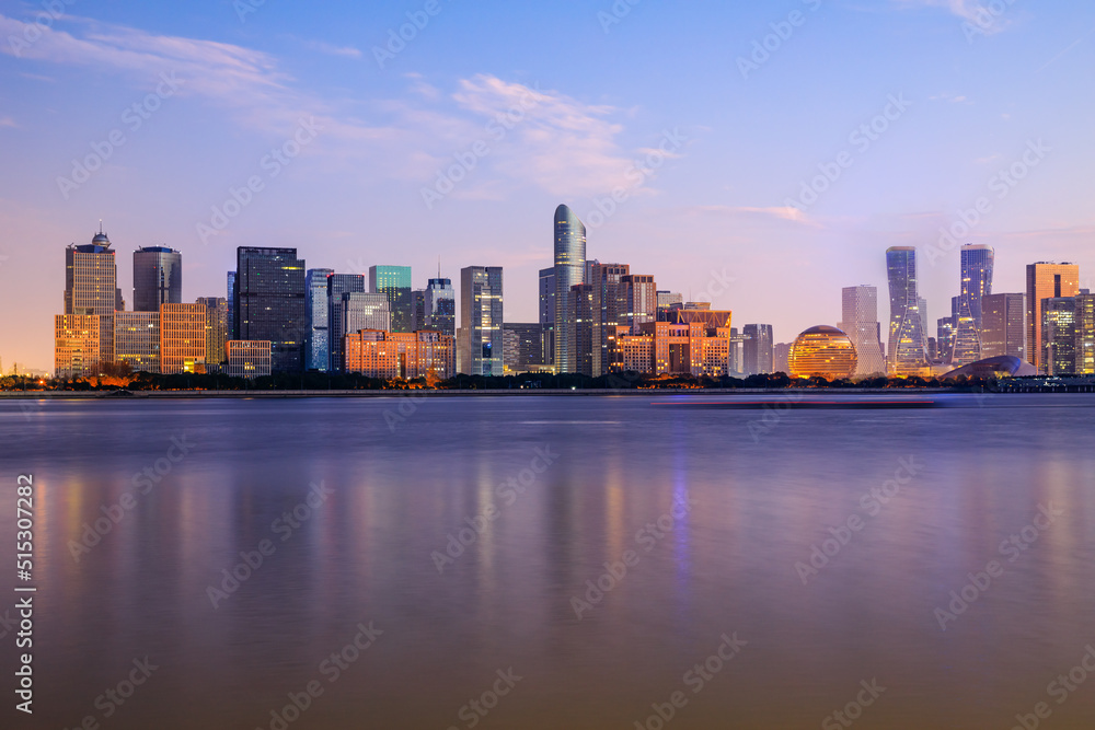 Panoramic skyline and modern commercial buildings with river in Hangzhou, China.