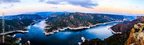 panormic 180 of beautiful dam at sunrise with beautiful colors in the sky and green mountains in the background, blue water , zimapan hidalgo  photo