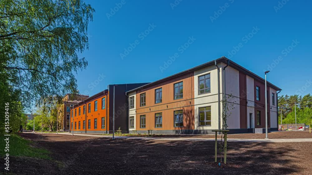 Static shot of the exterior of a wooden container house which is a local school on a clear sunny day in timelapse. Static shot of the exterior of a wooden container house which is a local school on a clear sunny day in timelapse.