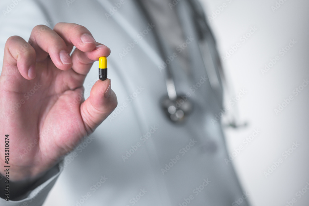 Fototapeta premium Doctor hand holding pill, medical treatment concept.