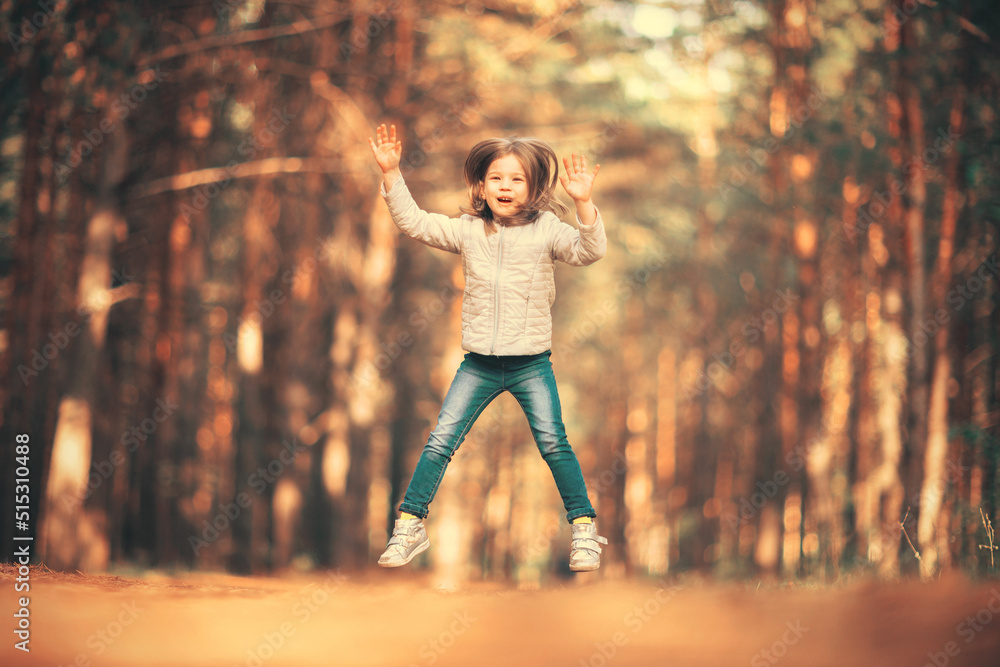 Little girl jumping high in the park