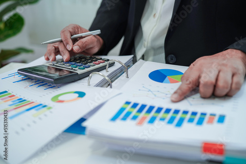 Businessman working and analysis with statistic graph in office. © manassanant