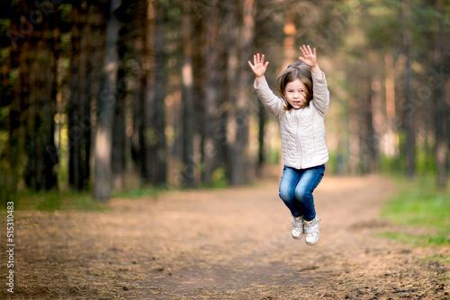 Little girl jumping high outdoors