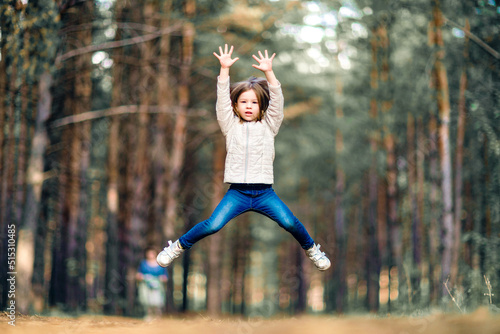 Little girl jumping high in the park