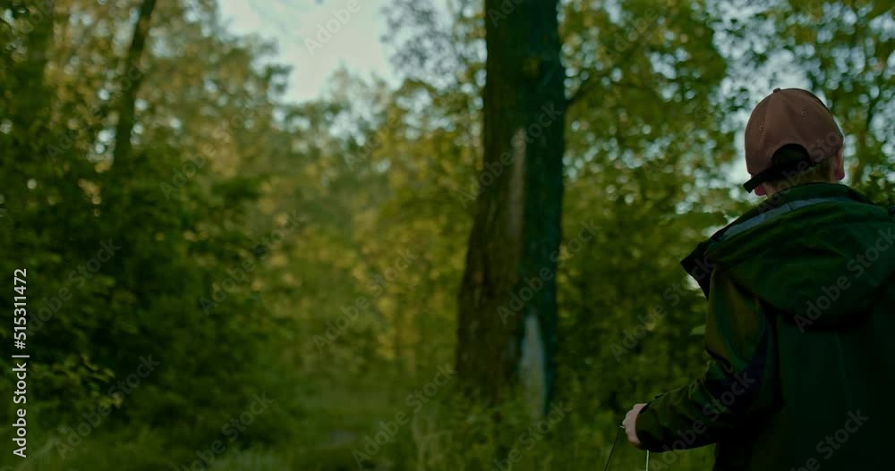 schoolboy is walking in forest in summer morning, going to catch fish in lake, 4K, Prores schoolboy is walking in forest in summer morning, going to catch fish in lake, 4K, Prores