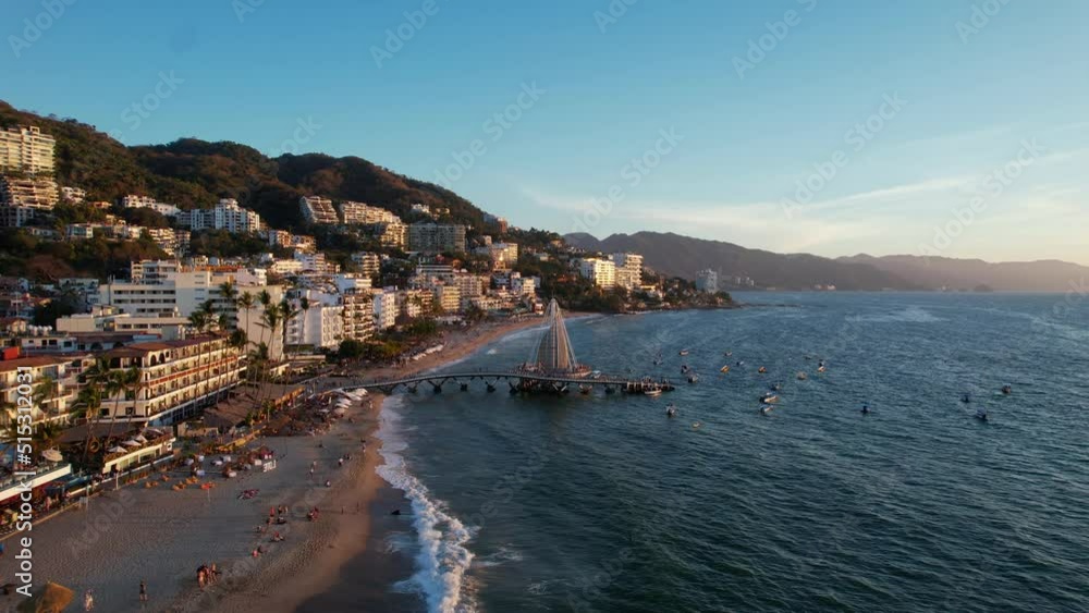 Puerto Vallarta riviera at sunset with oceanfront hotels and resorts on the mountain, aerial Puerto Vallarta riviera at sunset with oceanfront hotels and resorts on the mountain, aerial