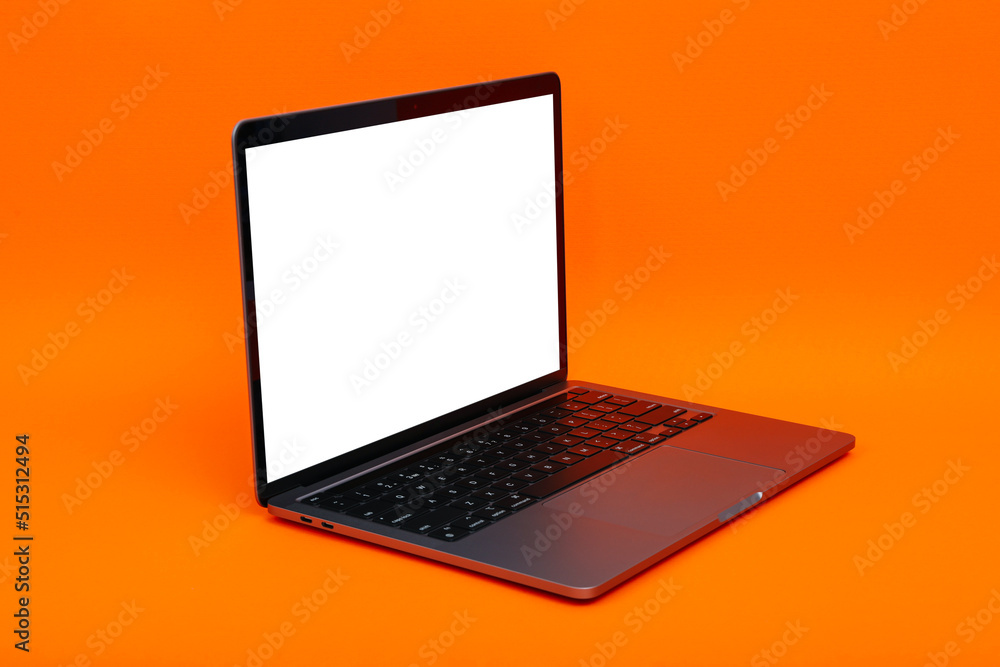 Laptop with blank screen on orange background Laptop with blank screen on orange background