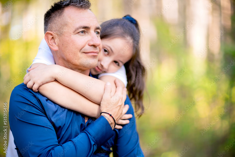Fototapeta premium Little girl hugging her father.