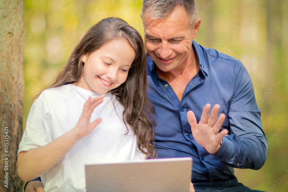 Father and daughter say hello during online video cal Father and daughter say hello during online video cal