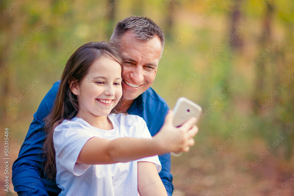Father and daughter with funny faces taking selfie Father and daughter with funny faces taking selfie