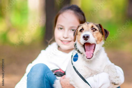 Little girl hugging her dog. © watman